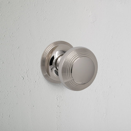 Polished Nickel Poplar Sprung Door Knob On White Background