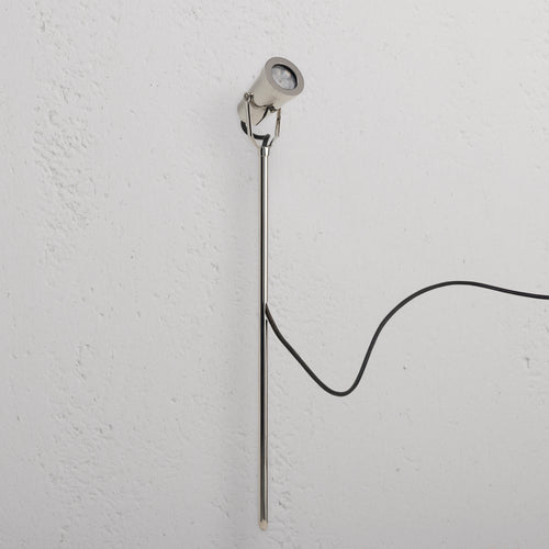 Cambridge Ground Spotlight 24V in polished nickel, a sleek outdoor spotlight with black power cord attached.